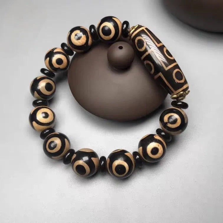Agate Tibetan dzi bead bracelet with three-eye design and polished finish