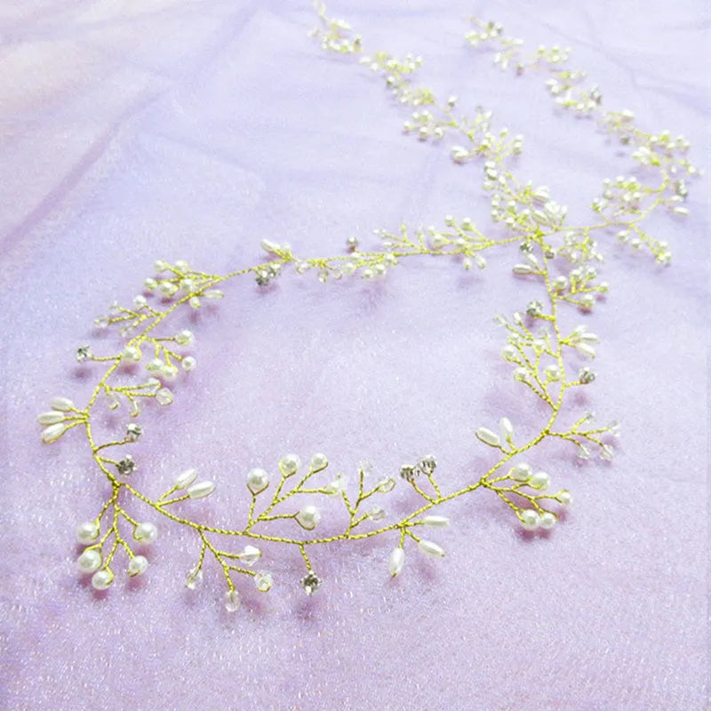 Bride's long hair band with pearls and crystals on a gold-coloured wire, shown coiled.