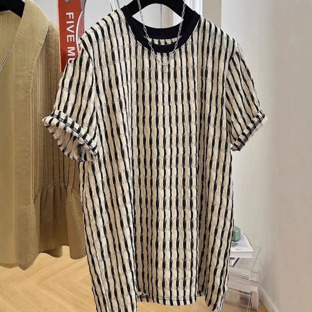 A man's loose-fitting black and white striped casual pullover shirt made from linen and silk.