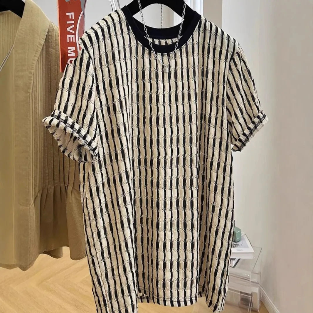 A man's loose-fitting black and white striped casual pullover shirt made from linen and silk.