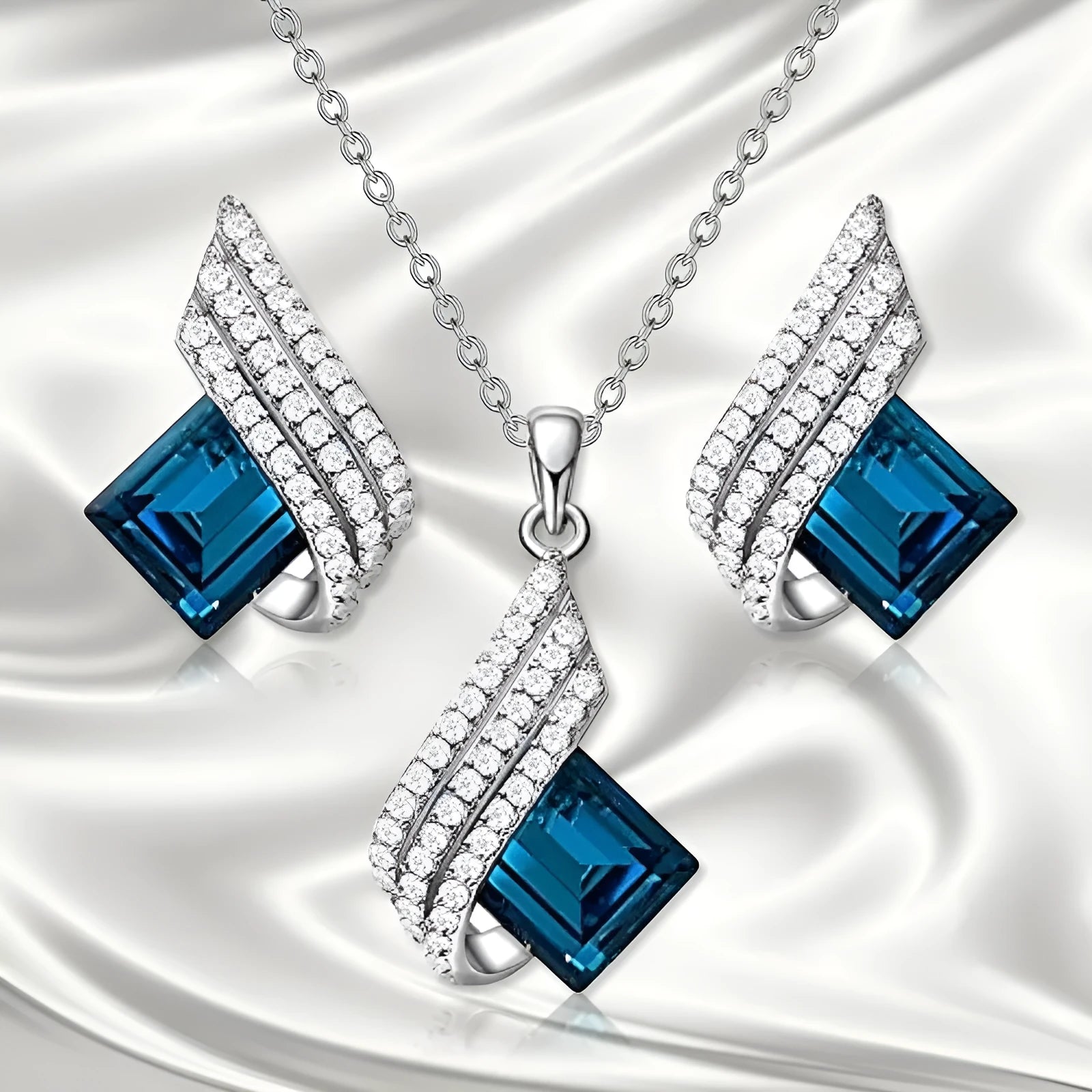 Women's cross chain necklace and earrings set with glass pendant and electroplated finish.