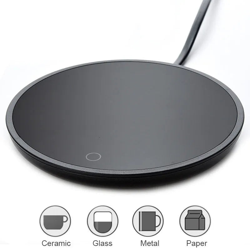 Black coffee cup warmer plate with temperature switch on desk next to mug