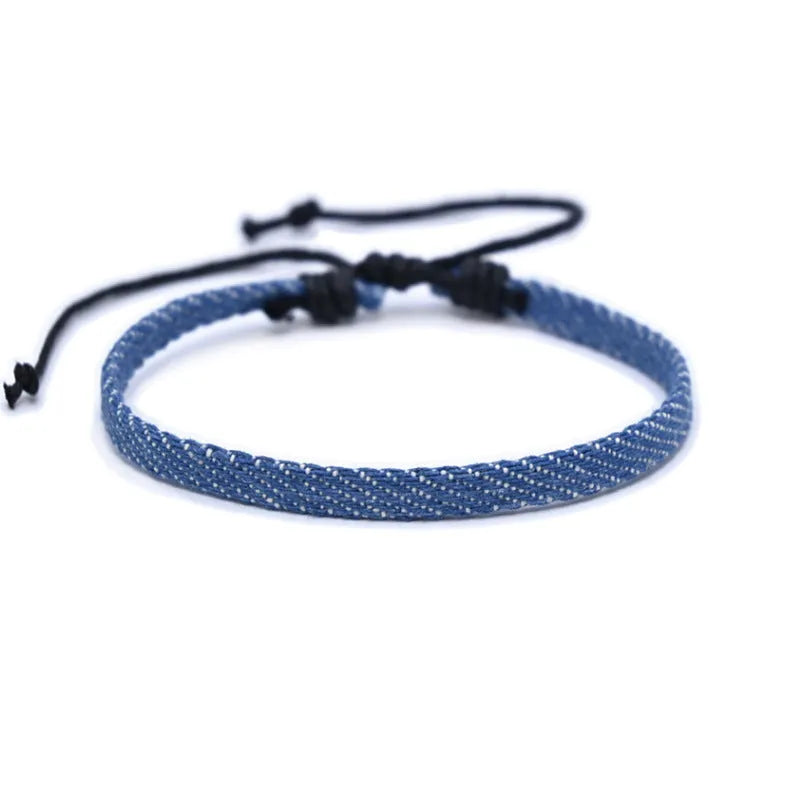 Handmade denim fabric wristband carrying strap in mixed materials with adjustable closure
