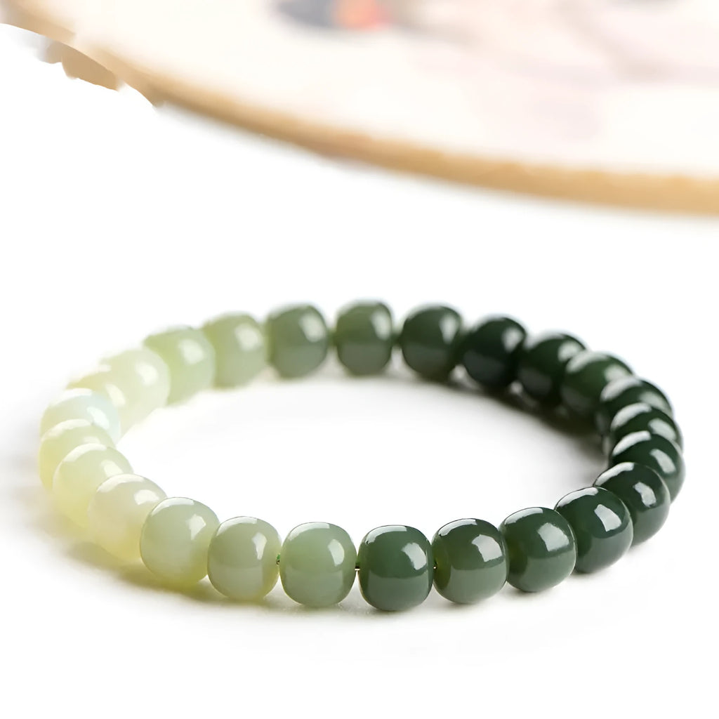Polished Hetian jade bracelet with gradient clear water colour on wrist.