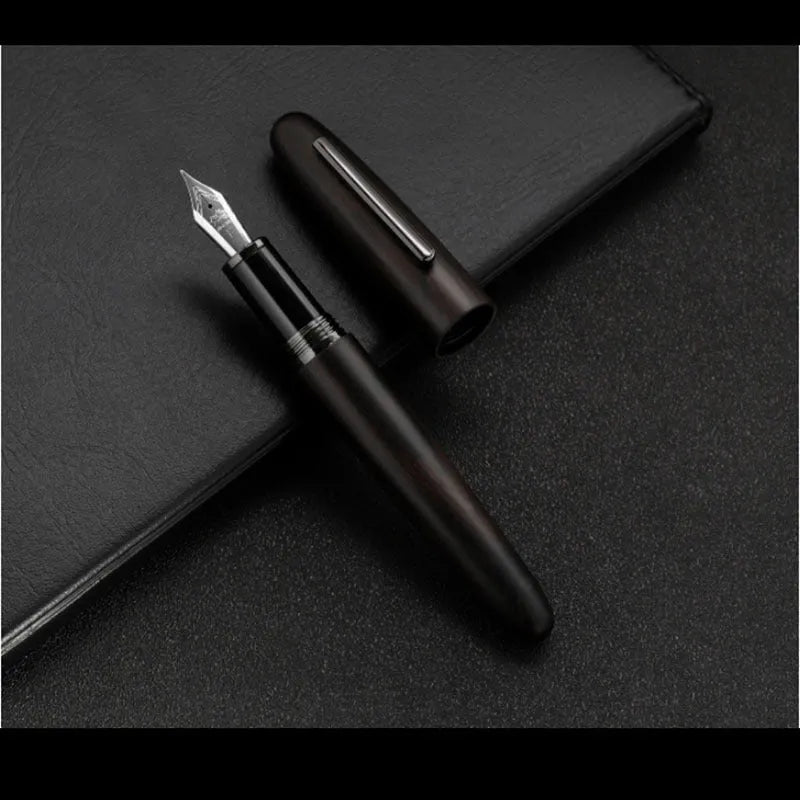 Wooden fountain pen with rotating cap showing natural wood grain