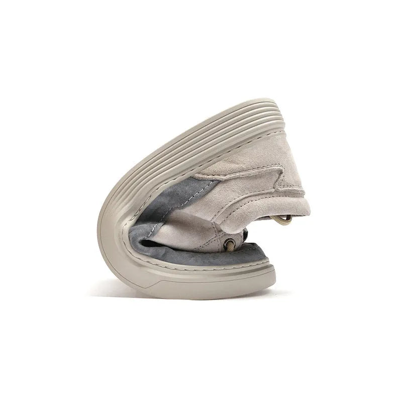 Men's grey low-top pigskin leather skate shoes with flat rubber sole and lace-up front.