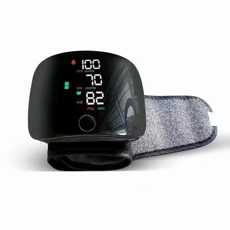 Black wrist rechargeable blood pressure monitor with USB port and digital display.