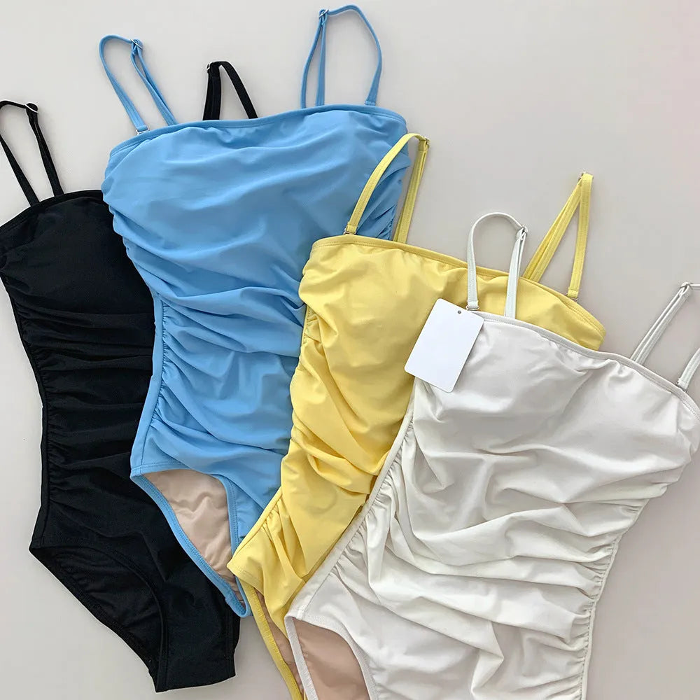 Sling style belly pleated one-piece swimsuit in slim fit available in blue, white, yellow, black colours