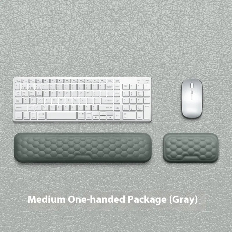Customisable memory foam mouse wrist pad with black cloth cover on a desk.