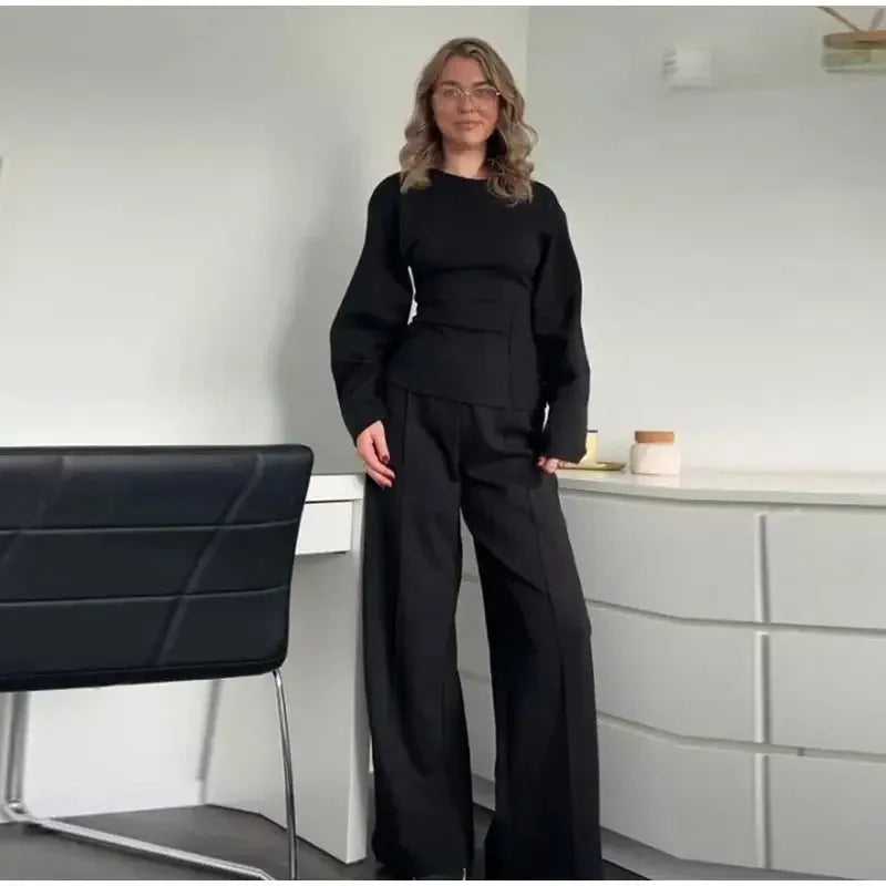Women's apricot polar fleece suit set with long sleeve top and wide leg trousers on a hanger.
