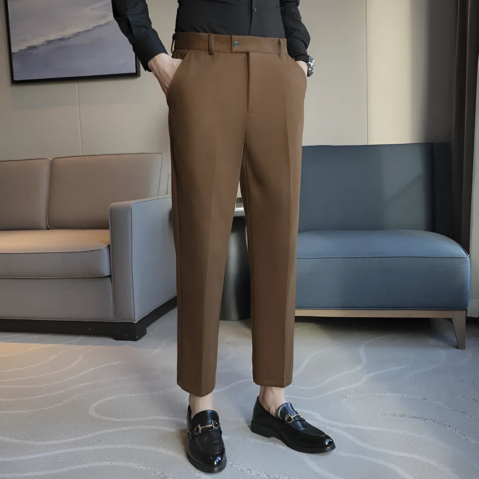 Men's straight leg brown corduroy trousers with an elasticated waistband on a hanger