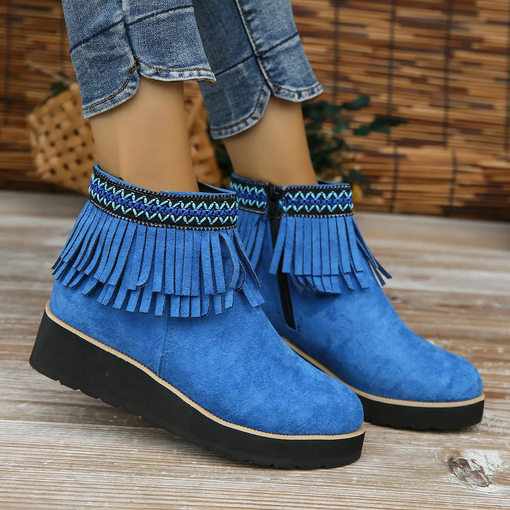 Women's dark brown suede wedge ankle boot with side zip, tassel, and thick rubber sole.