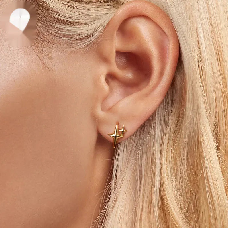 Minimalist star design ear clips in sterling silver with oxidised finish and XINGX elements