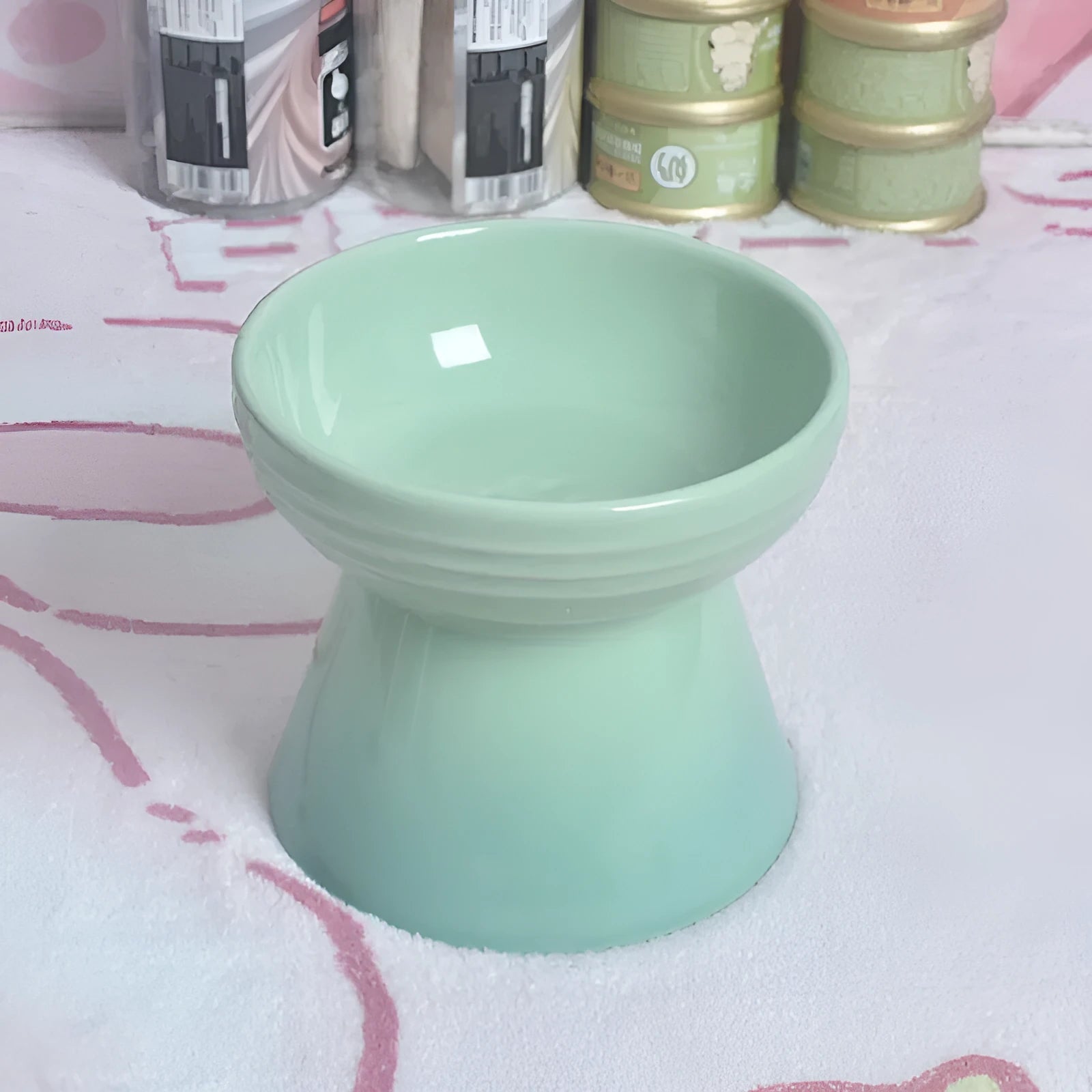 A white ceramic pet bowl with a high foot and raised neck protector to prevent tipping.