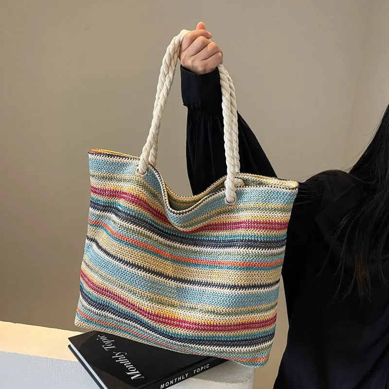 Blue straw-woven nylon shoulder bag with large main compartment and single strap