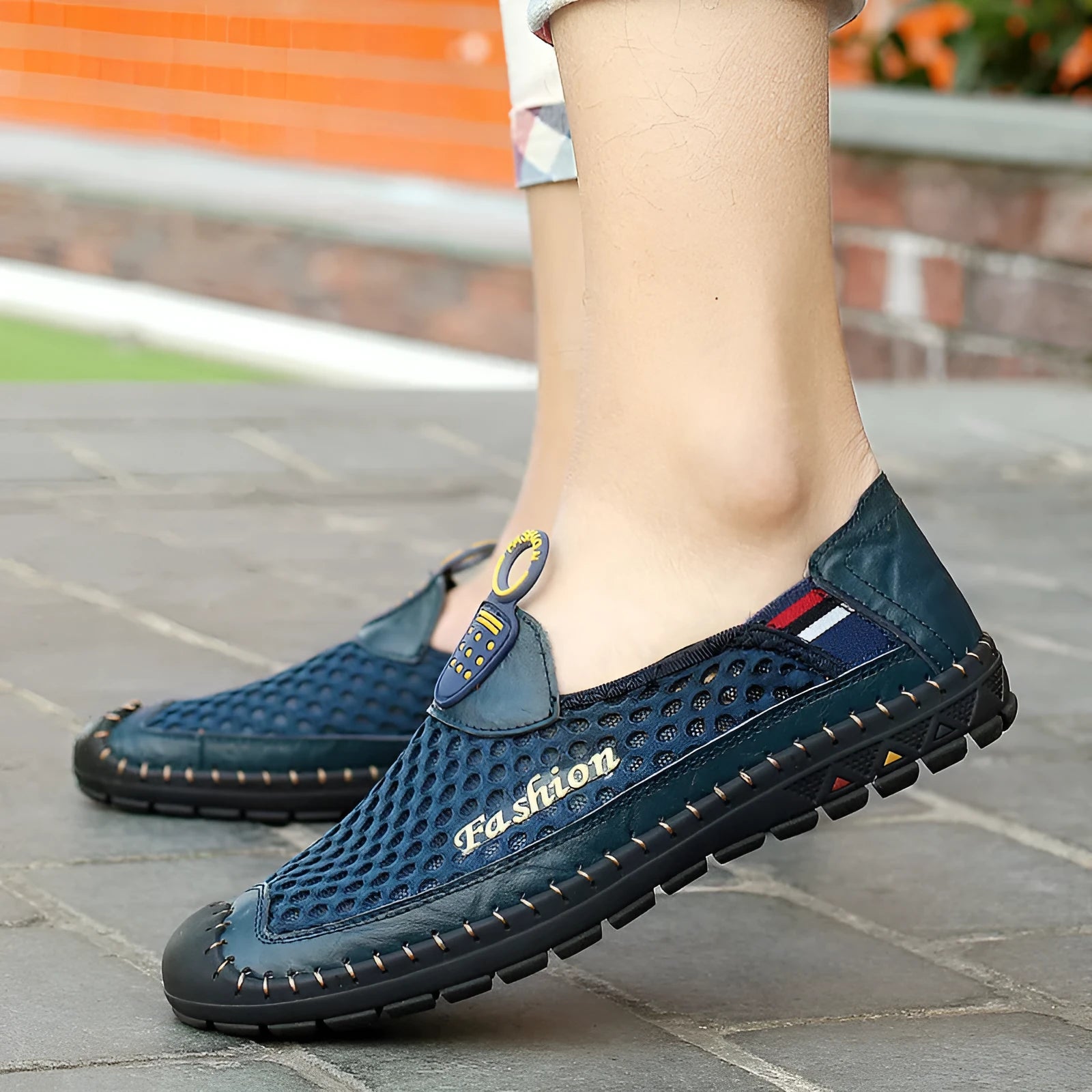 Men's brown breathable mesh casual shoes with round toe and rubber sole on a plain background.