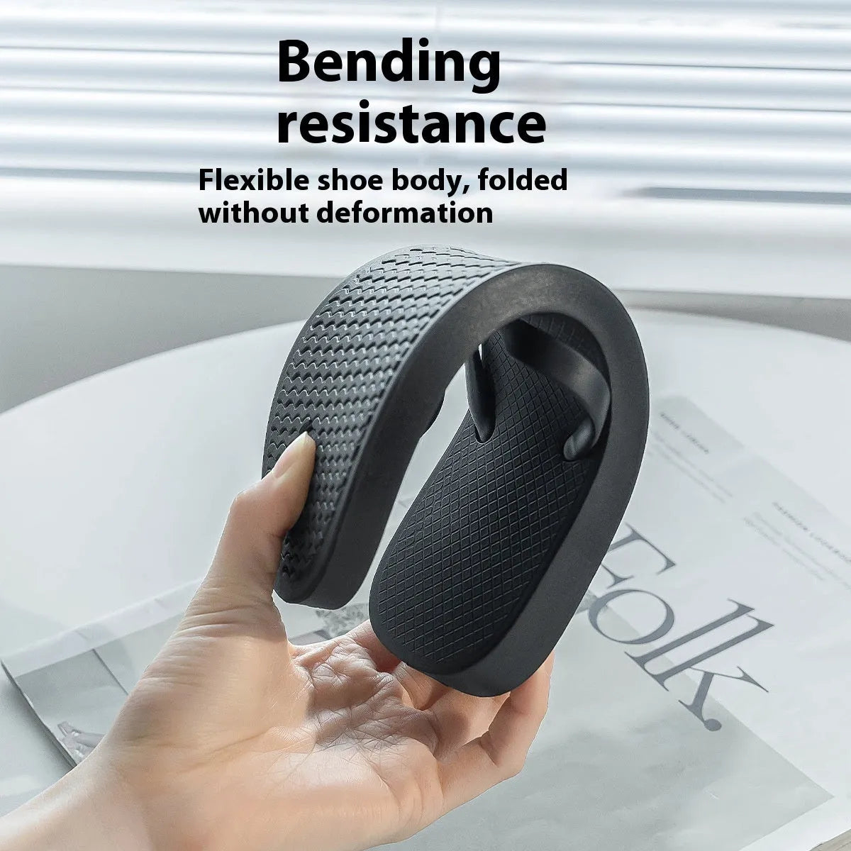 Foldable casual slippers with a hollow-out plastic upper and non-slip PVC sole in black colour.