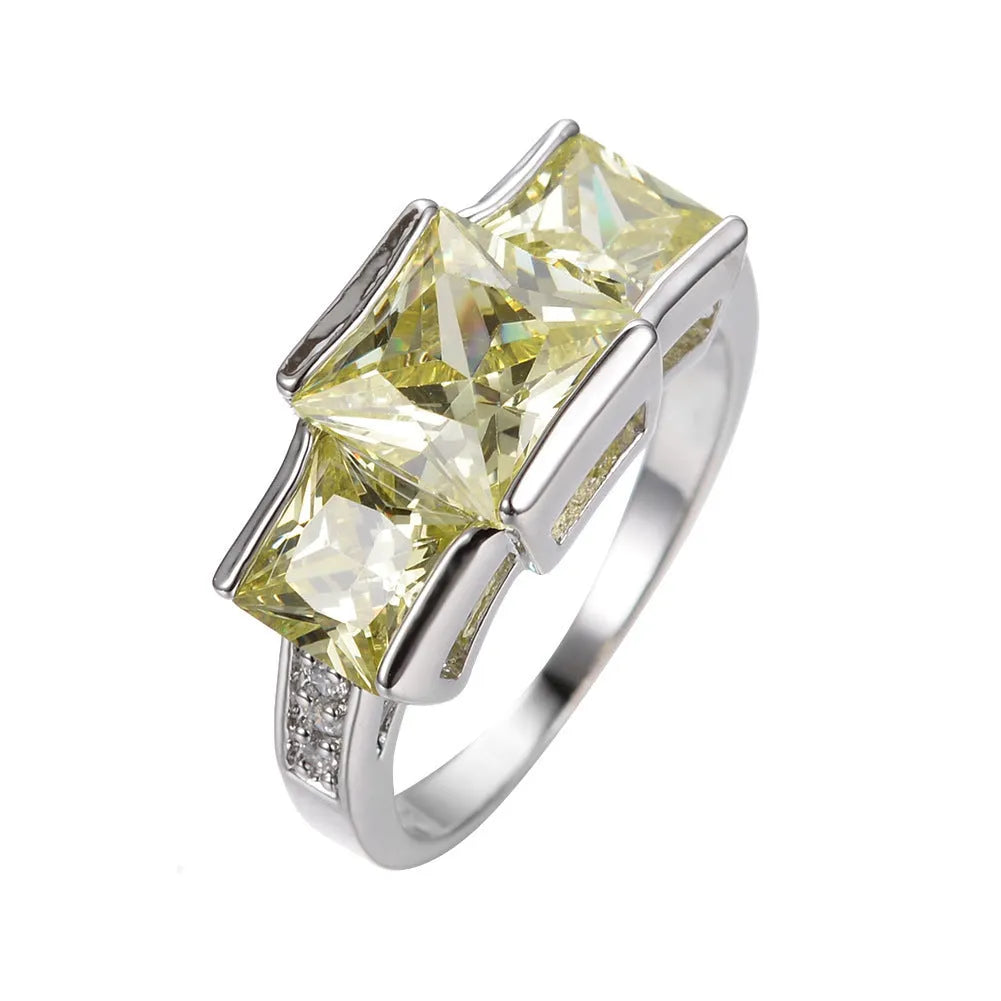 Geometric copper ring for women in champagne colour on a grey background, showing size 8.
