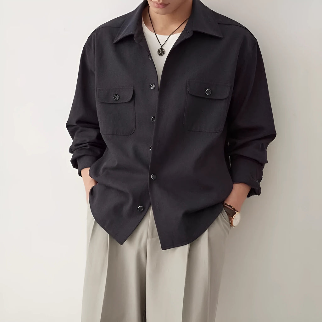 Men's light sand rice coloured cotton blend lapel shirt laid flat, showing long sleeves and simple collar design.