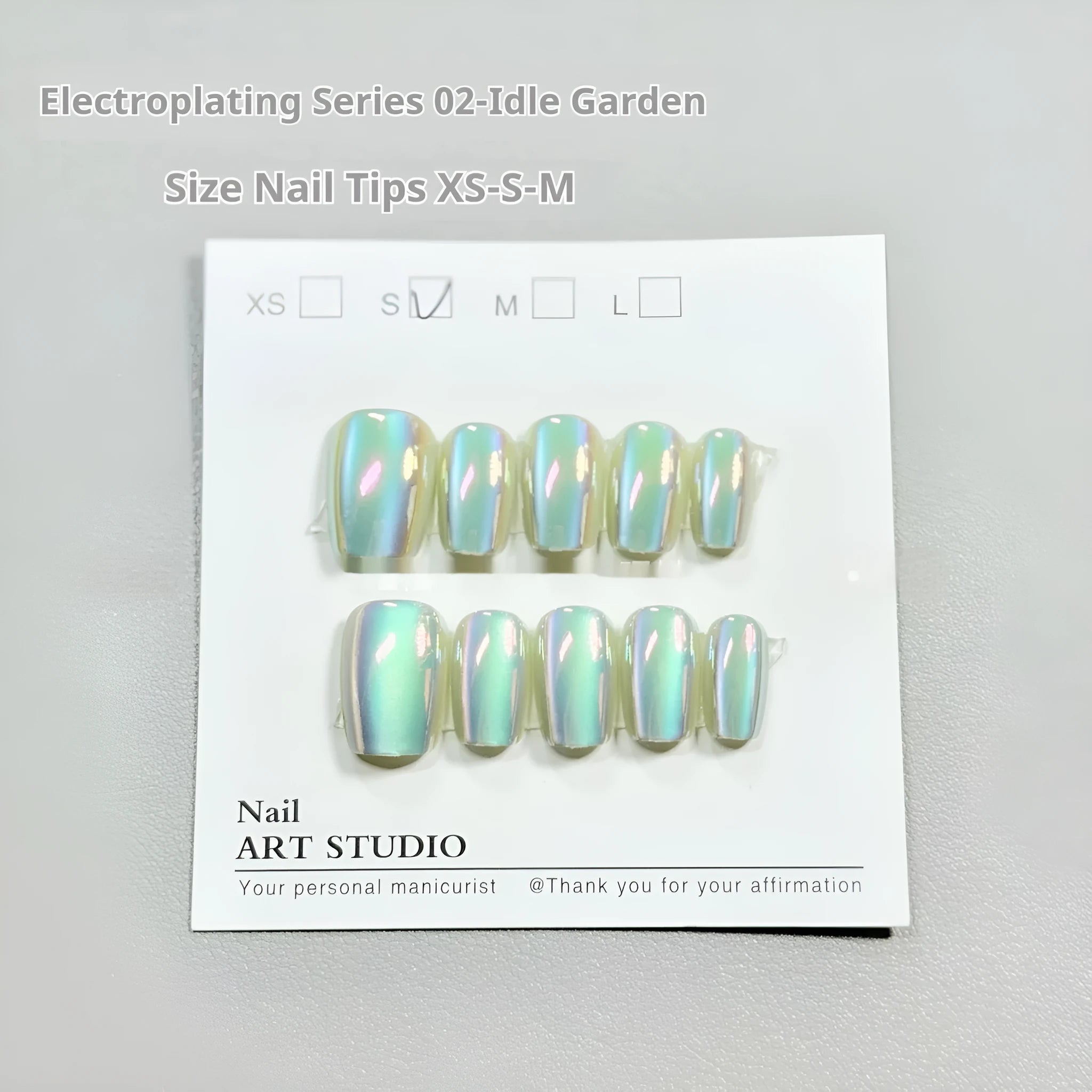 Set of electroplated Cat's Eye false nails in Aurora style showing short ladder shapes in XS, S, and M sizes.