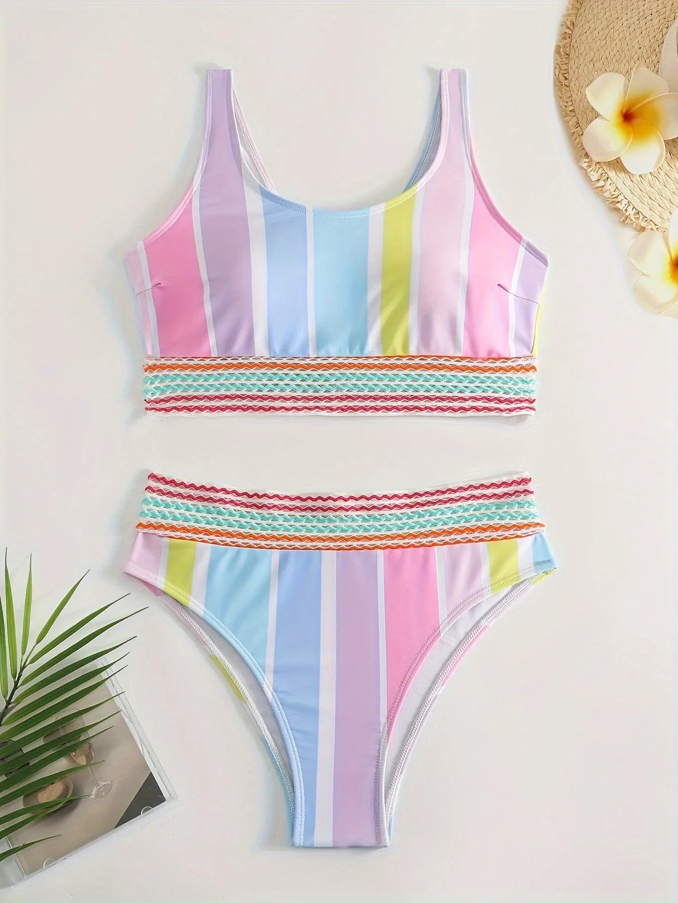 Women's striped two-piece bikini set in a sports casual design on a mannequin.