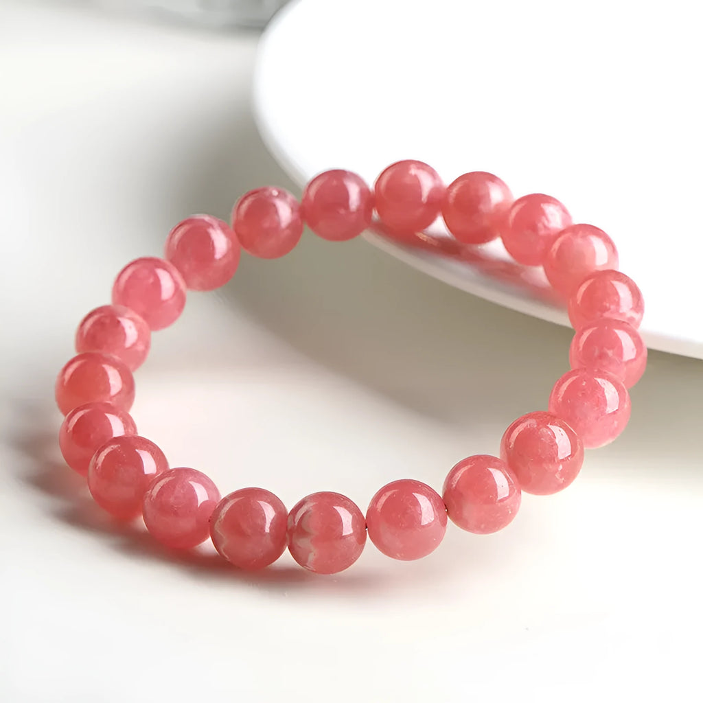 Natural red rhodochrosite crystal bracelet with geometric beads and longevity lock closure
