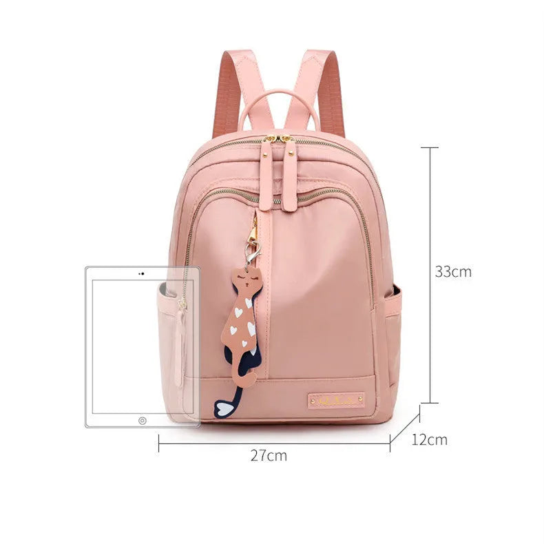 Women's black nylon casual backpack with double shoulder straps showing internal compartments and waterproof features