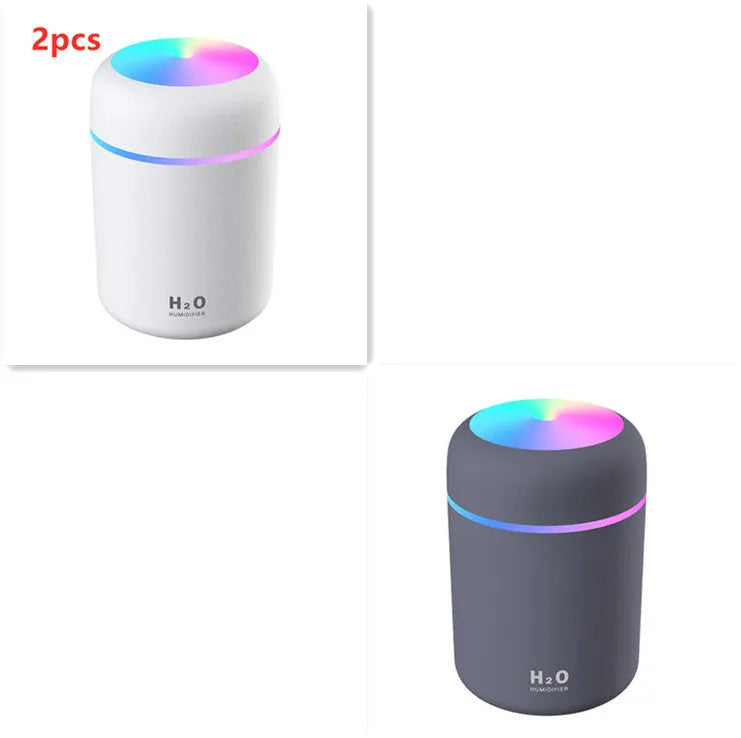 Pink USB portable humidifier with 300ml water tank on wooden desk surface