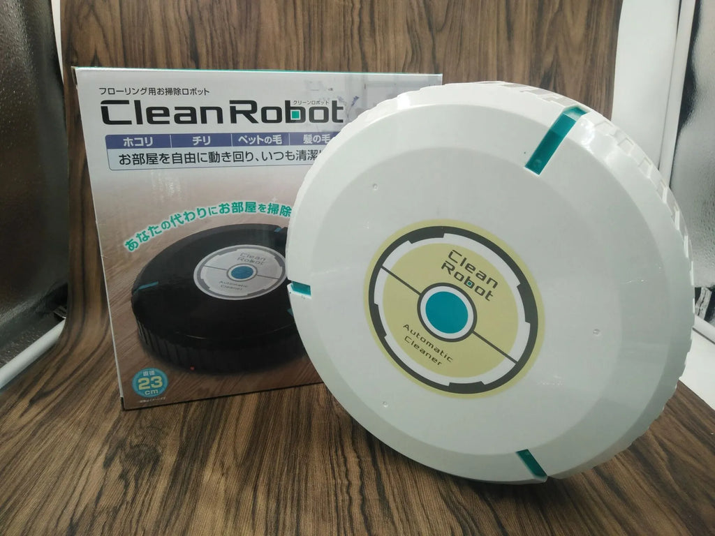 Black AC automatic sweeping robot vacuum cleaner on a wooden floor.