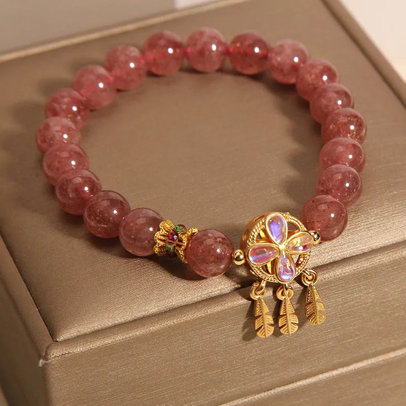 Women's strawberry quartz bracelet with four-leaf dream catcher pendant in natural crystal tones