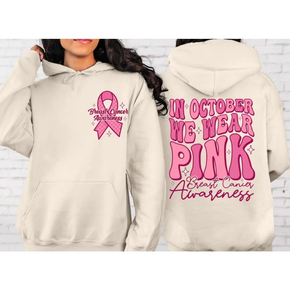 Women's pink breast cancer awareness pullover hoodie with retro graphic design and side seam pockets.