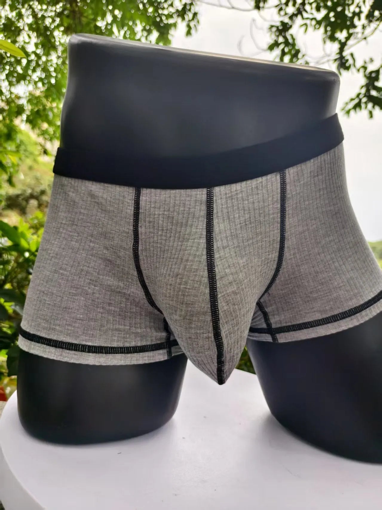 Men's thin fibre boxer shorts in army green, shown laid flat to display hip lift design.