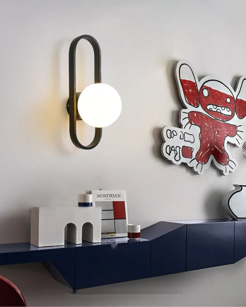 Minimalist wall lamp with glass shade and iron body in black or gold finish showing 12W tri-colour light source