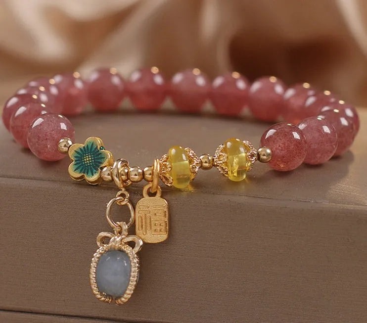 Red women's beaded bracelet with natural strawberry quartz stones and sparkling rhinestone accents.