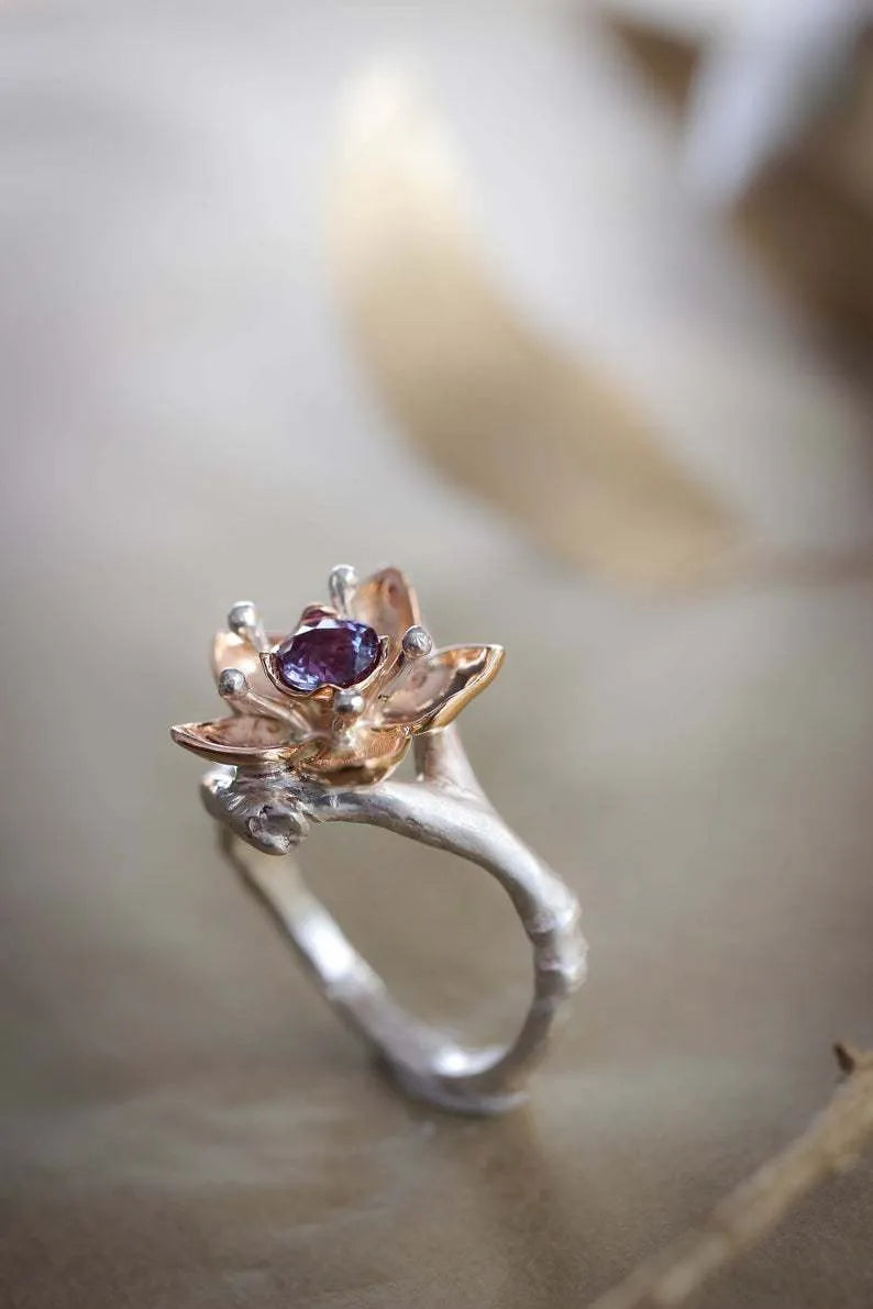 Silver two-tone geometric floral pattern women's alloy ring on a plain background.