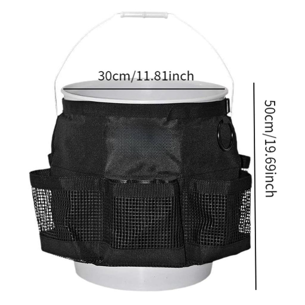 Black cylindrical polyester storage bag hanging on a 5-gallon barrel for outdoor tool organisation