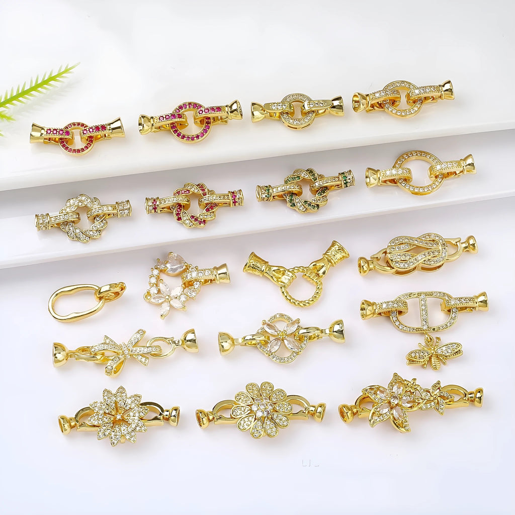 Small gold colour necklace clasp buckle for DIY jewellery on a white background.