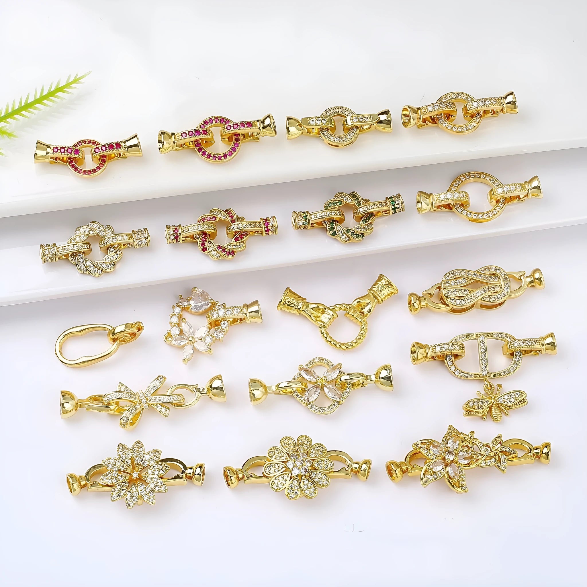 Small gold colour necklace clasp buckle for DIY jewellery on a white background.