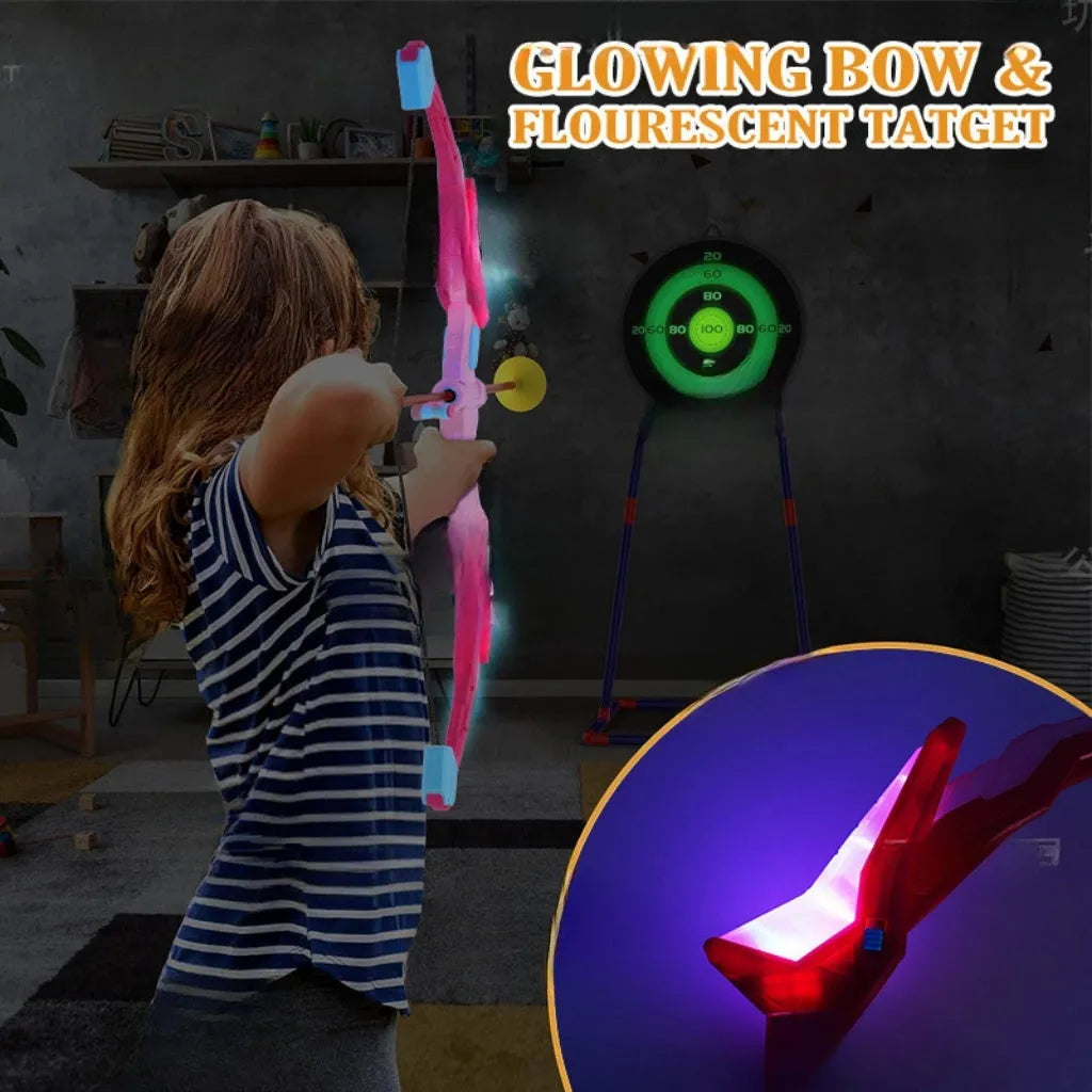 Children's bow and arrow set with green detachable bow, target tube, and light-up arrows on grass. Blue and pink colour options available.
