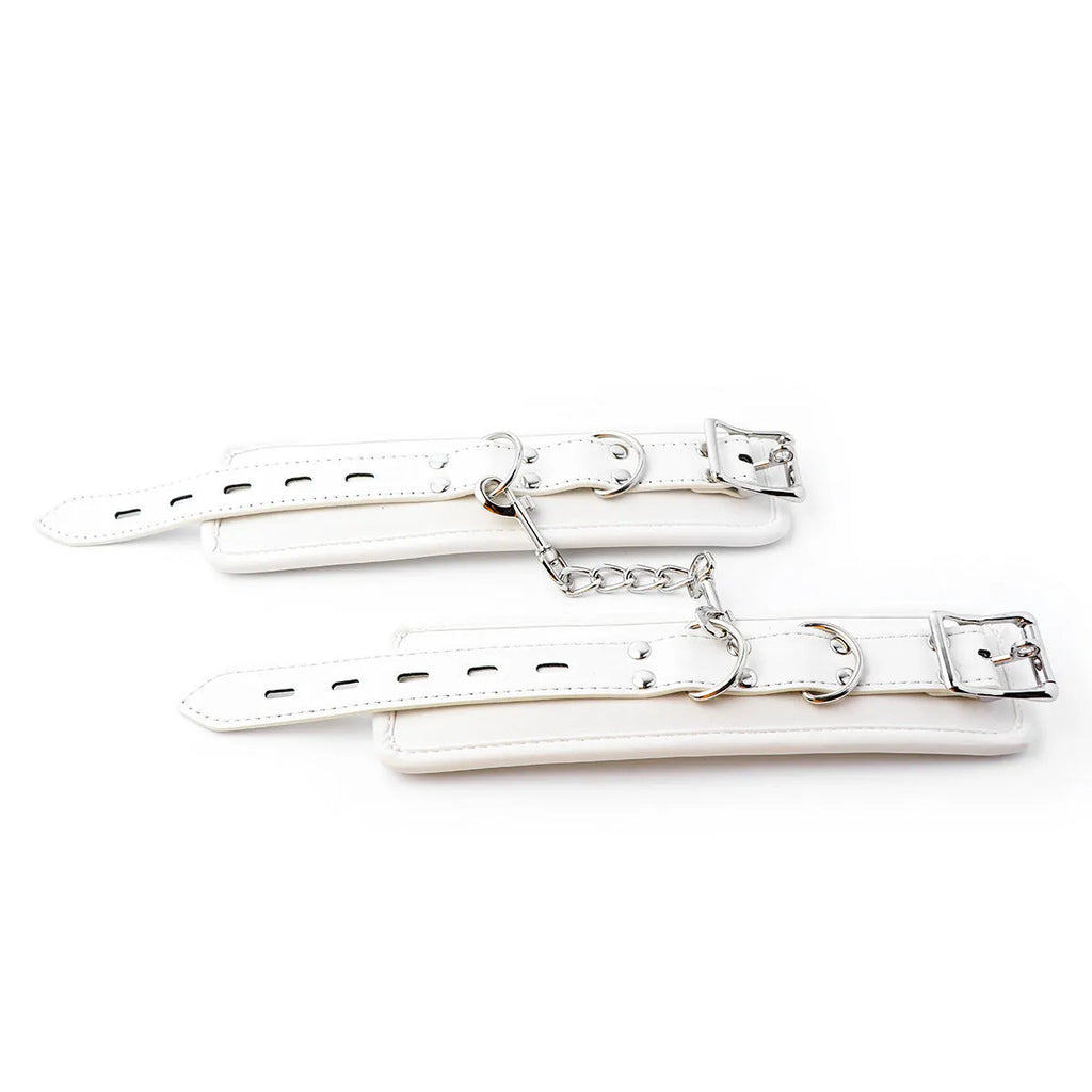 White PU sponge bondage restraint set showing handcuffs, foot cuffs, and neck scarf