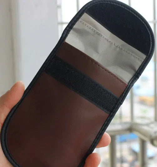 Black microfiber Faraday cage bag for blocking car key fob and mobile phone signals.
