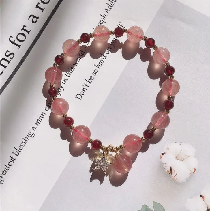 Handcrafted strawberry quartz crystal bracelet with green moon beads and peach blossom Hetian jade charm on adjustable string