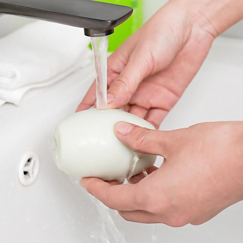 Green washable gel lint roller ball for pet hair removal on fabric