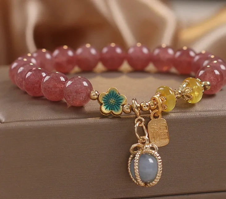 Red women's beaded bracelet with natural strawberry quartz stones and sparkling rhinestone accents.