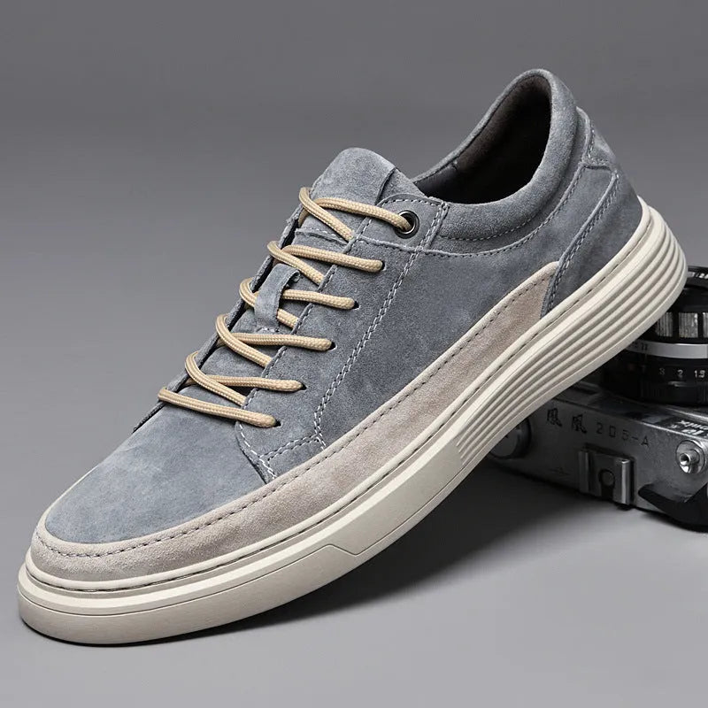 Men's grey low-top pigskin leather skate shoes with flat rubber sole and lace-up front.