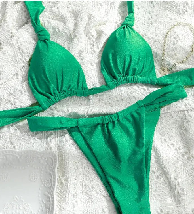 Women's pink bikini with knotted pleated straps and a briefs cut, shown on a model.