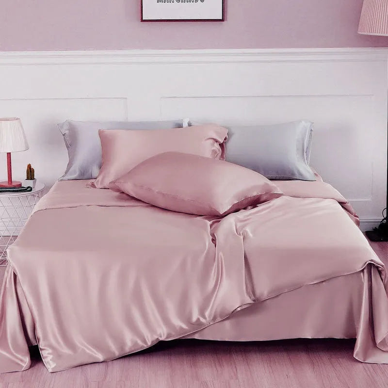 Reversible silk duvet cover folded to show Lotus Pink and pea green sides, with bright brown and silver blue colour swatches.