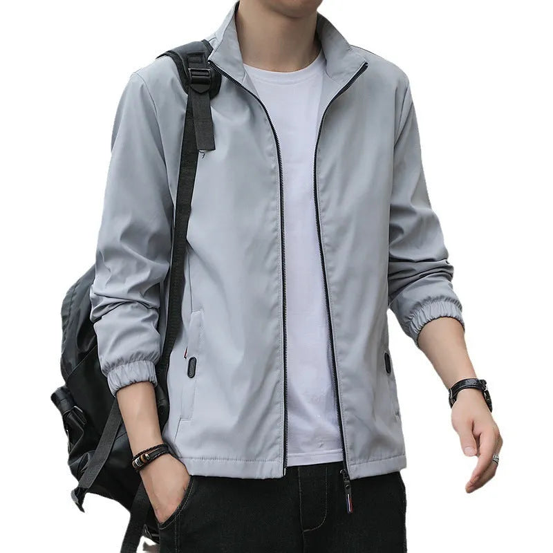 Korean style loose fit casual jacket in black with zip and patch pockets on a man.