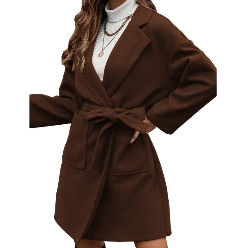 Long sleeve brown lapel button coat with a split belt, shown in a loose fit.