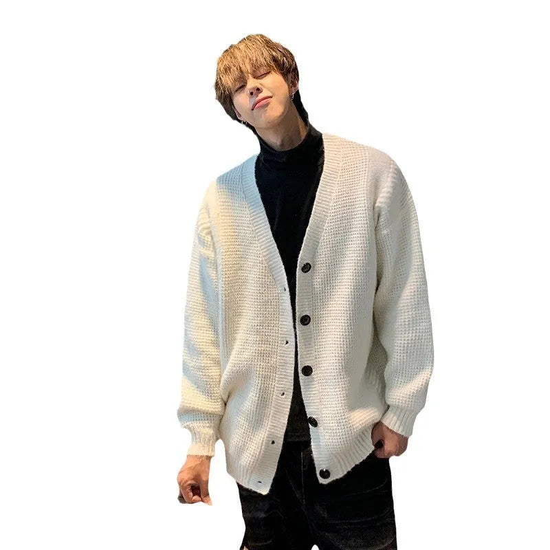 A man's loose-fitting V-neck knitted cardigan in a solid colour on a hanger.